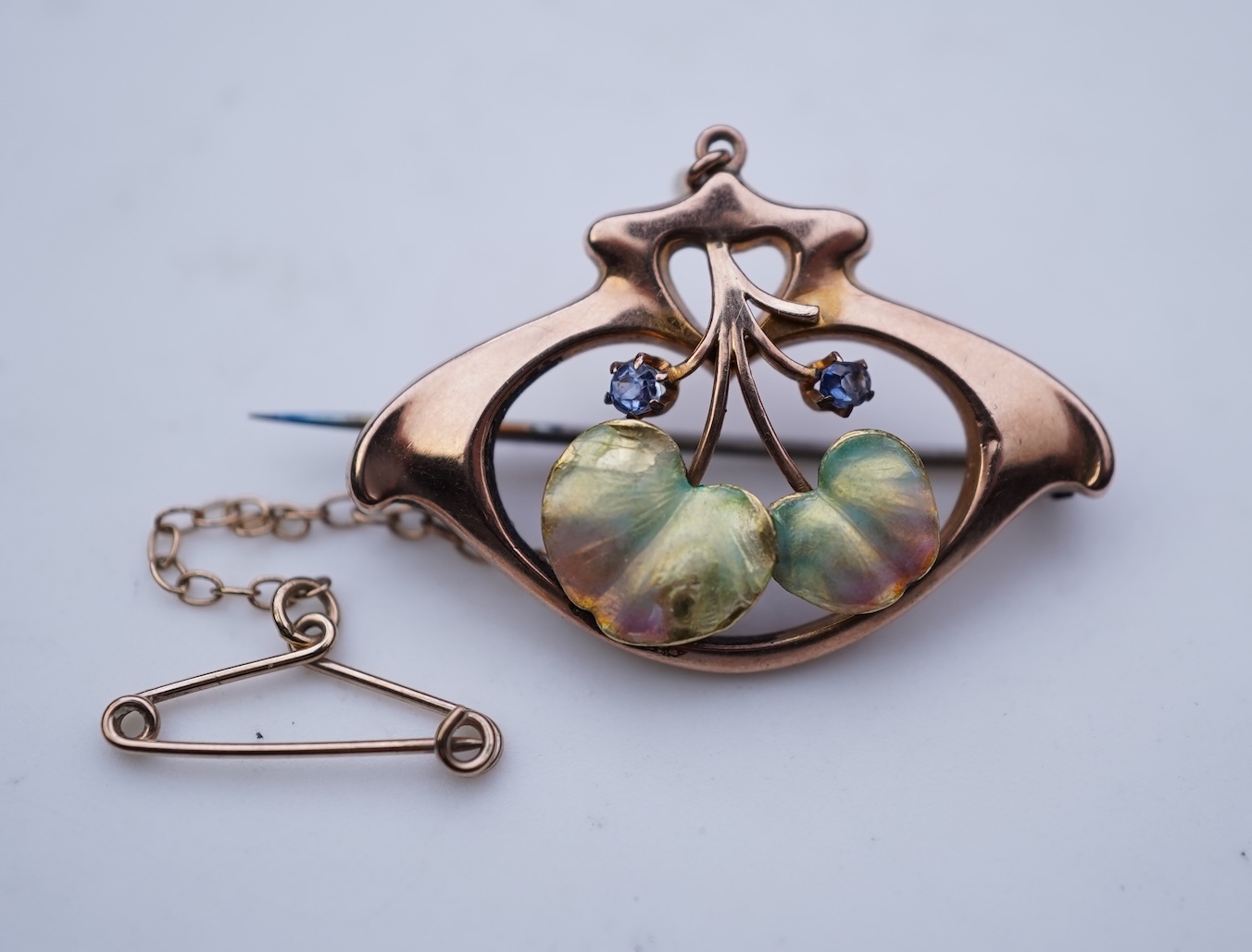 An attractive Art Nouveau enamel, sapphire and seed pearl brooch, early 20th century